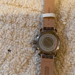 Women’s Coach watch brand new never worn. Silver face light brown band
